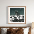 An art print with a cowboy's contemplative silhouette merging with a starry night over snow-capped mountains, reflecting the fusion of alt-western themes and the natural world from Big Seasons and Strange Pastures.